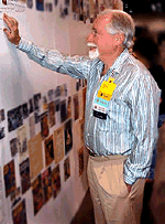 picture of Robert Silverberg reading a bulletin board