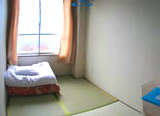 room with tatami mats and bedding on the floor